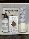 Gift set with skincare products and a productivity journal inside a box on a textured surface. Rest & Recharge Reviya Gifts