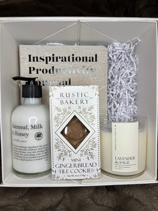 Gift set with skincare products and a productivity journal inside a box on a textured surface. Rest & Recharge Reviya Gifts