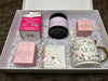 Gift set with raspberry leaf tea, calm product, belly butter, and a 'Mom' mug in a box.